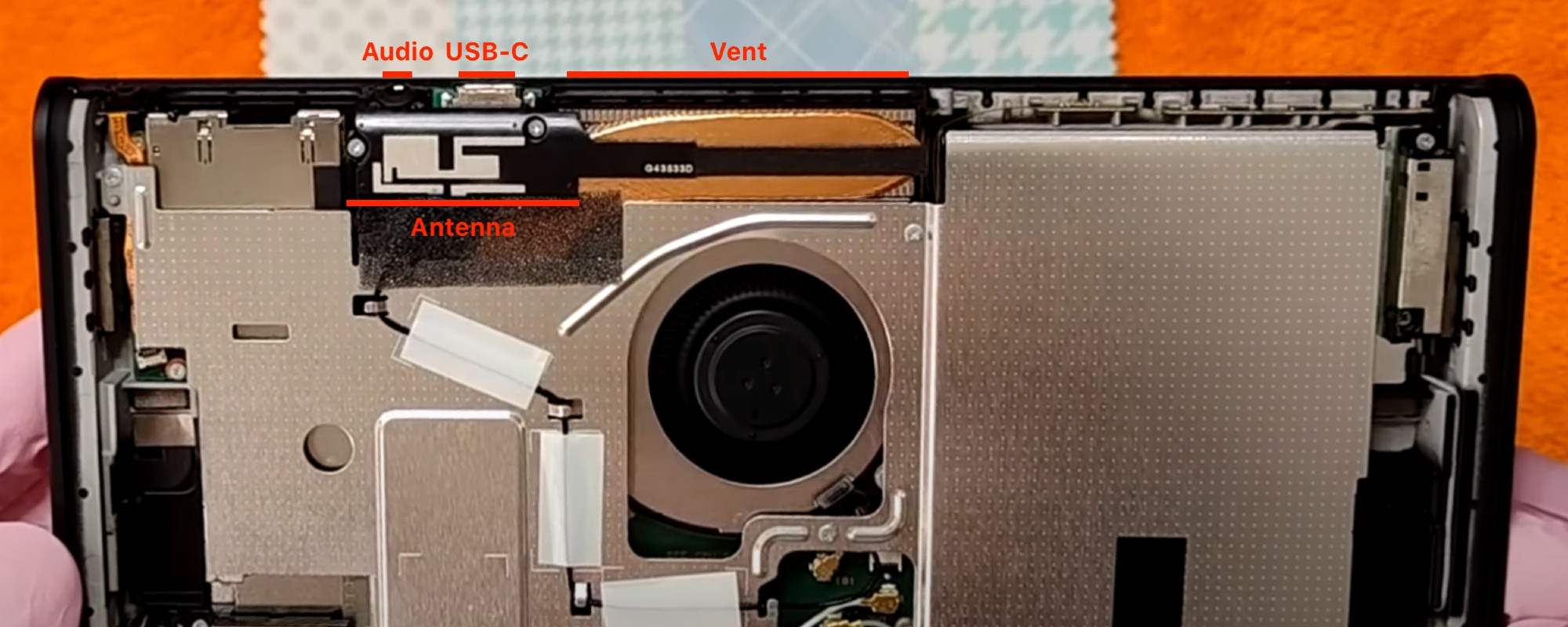Photo of Switch 2 interior, showing the audio jack, USB-C port, wireless antenna, and heat vent