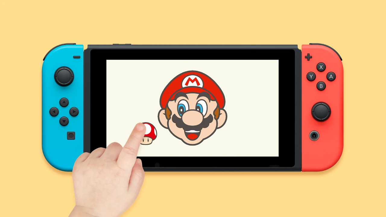 Hello, Mario! app running on a Switch 1; a toddler’s hand touching the console’s screen