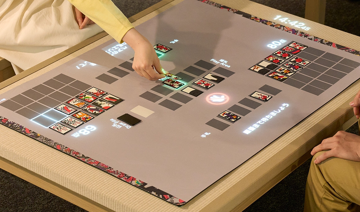 Official photo of the Nintendo Museum Hanafuda game, showing AR projection over a physical game board