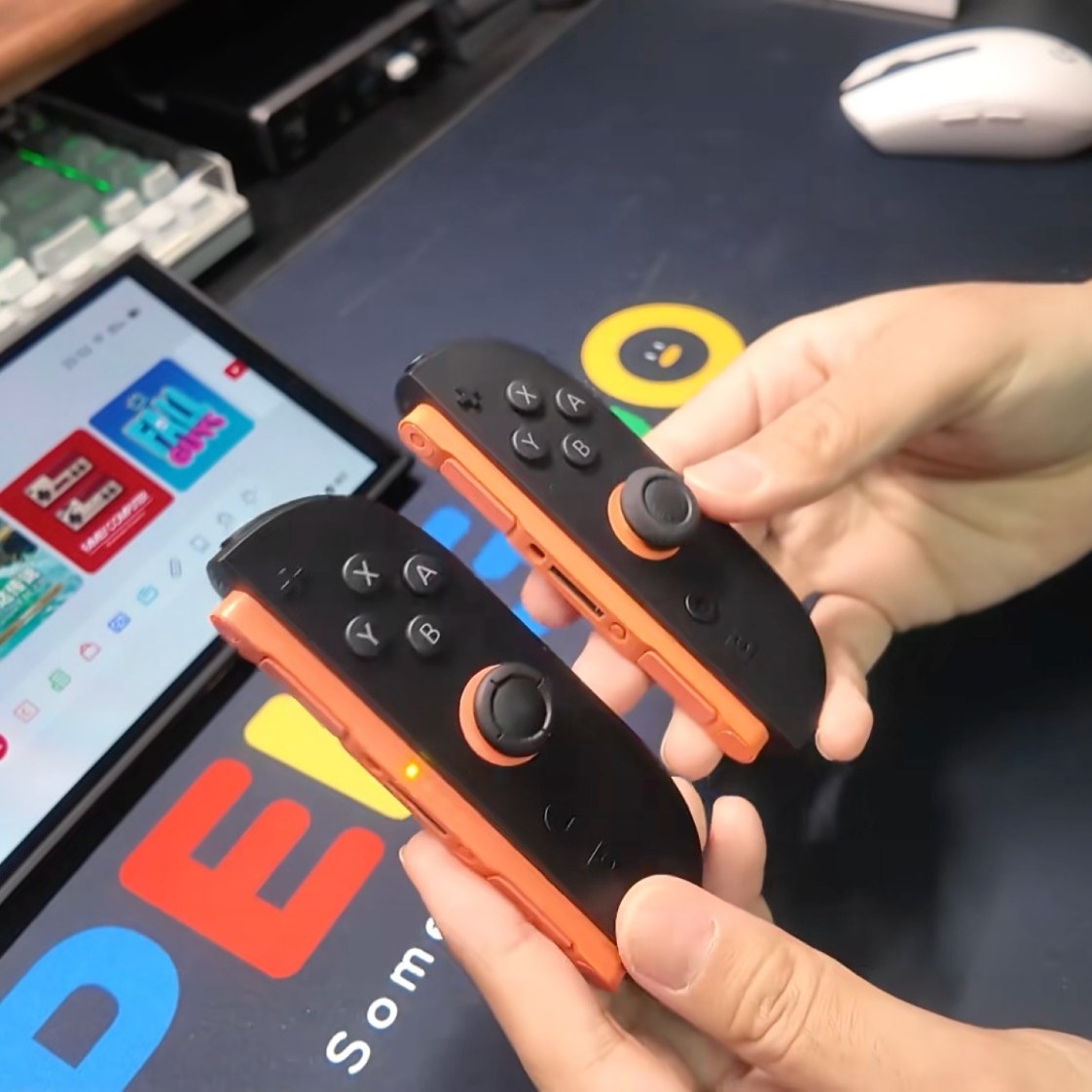 Screenshot of the review video, showing the 3rd party right Joy-Con and a genuine right Joy-Con side by side