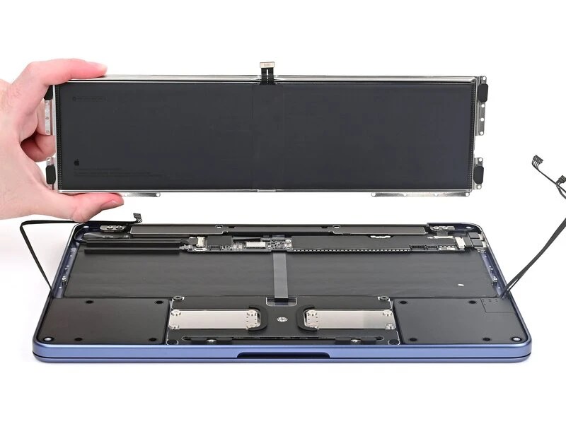 Photo of MacBook Neo with the battery removed and 3 cables disconnected