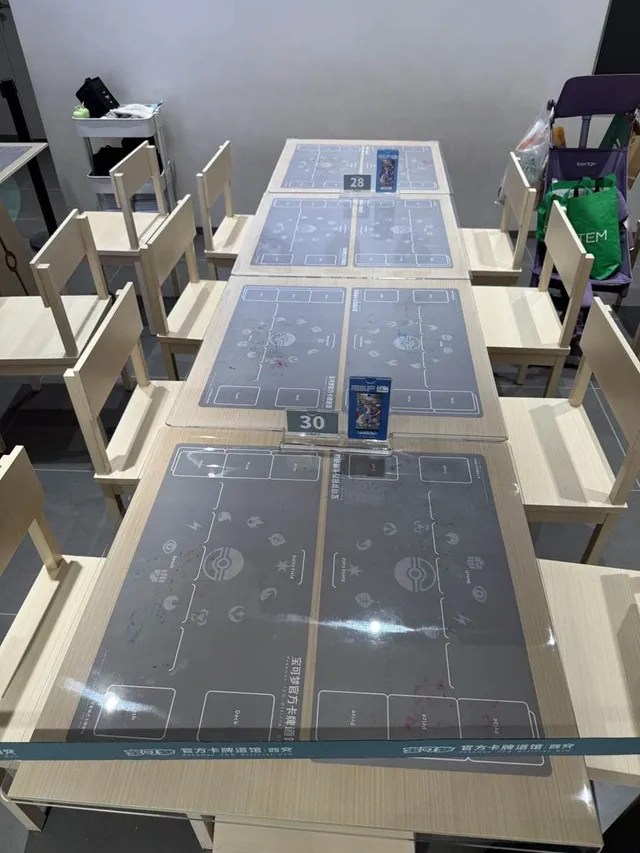 Photo of card game tables inside a Pokémon TCG Official Gym