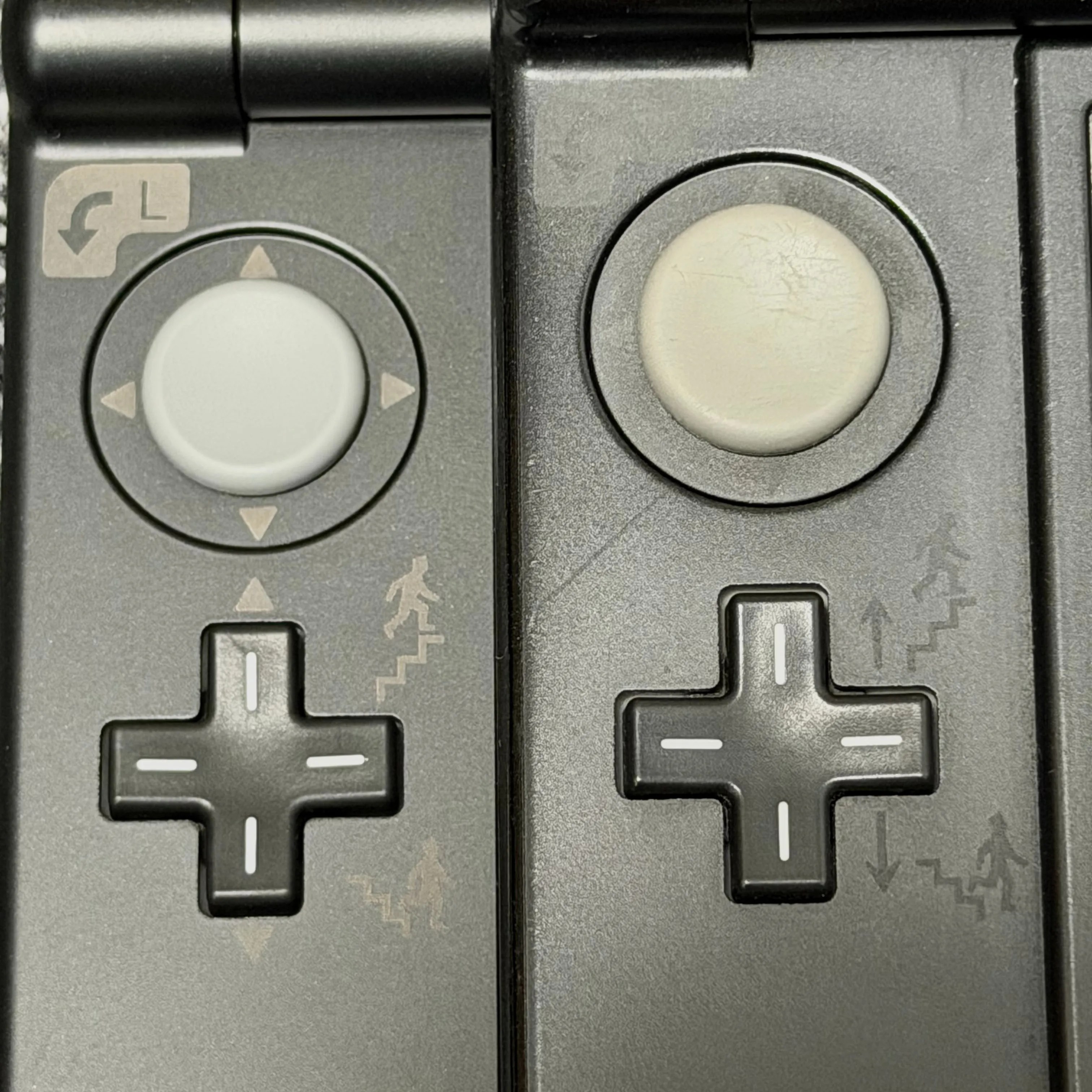 Comparison photo of the left circle pad and D-pad: V3 prototype on the left, final Louvre version on the right