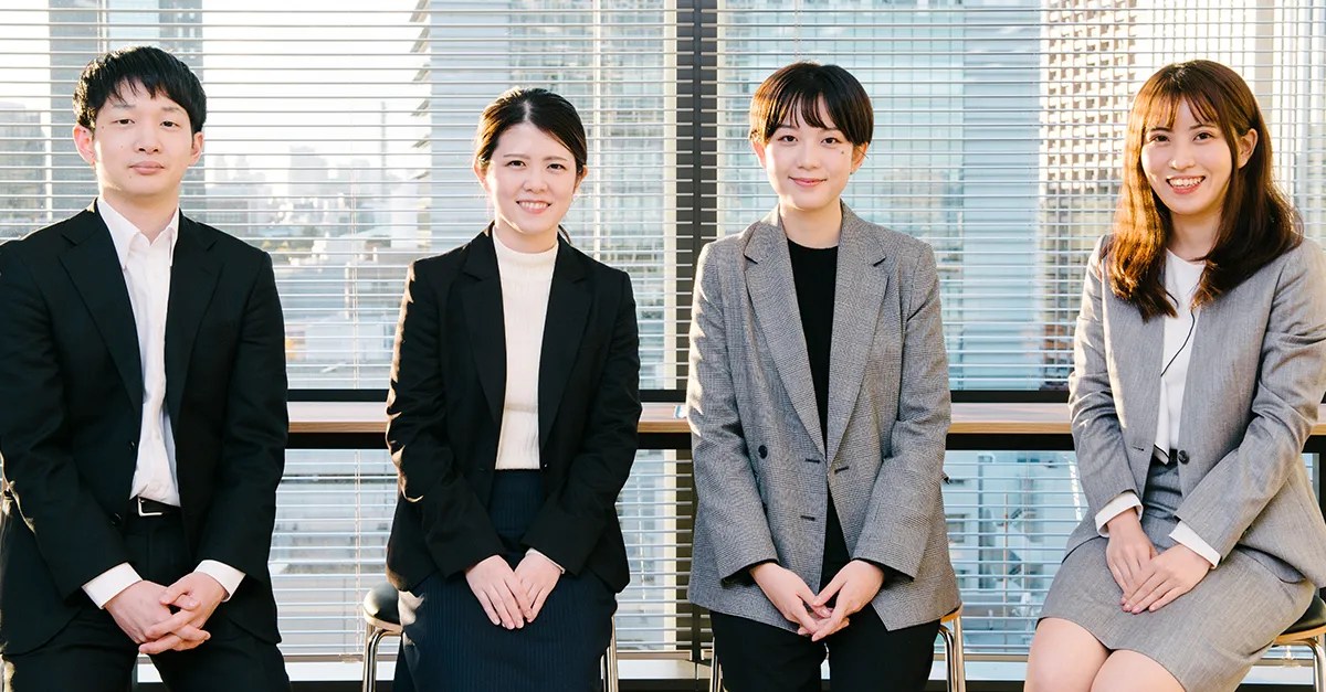 Photo of a group of Nintendo employees in their office, containing 3 East Asian women and 1 East Asian man