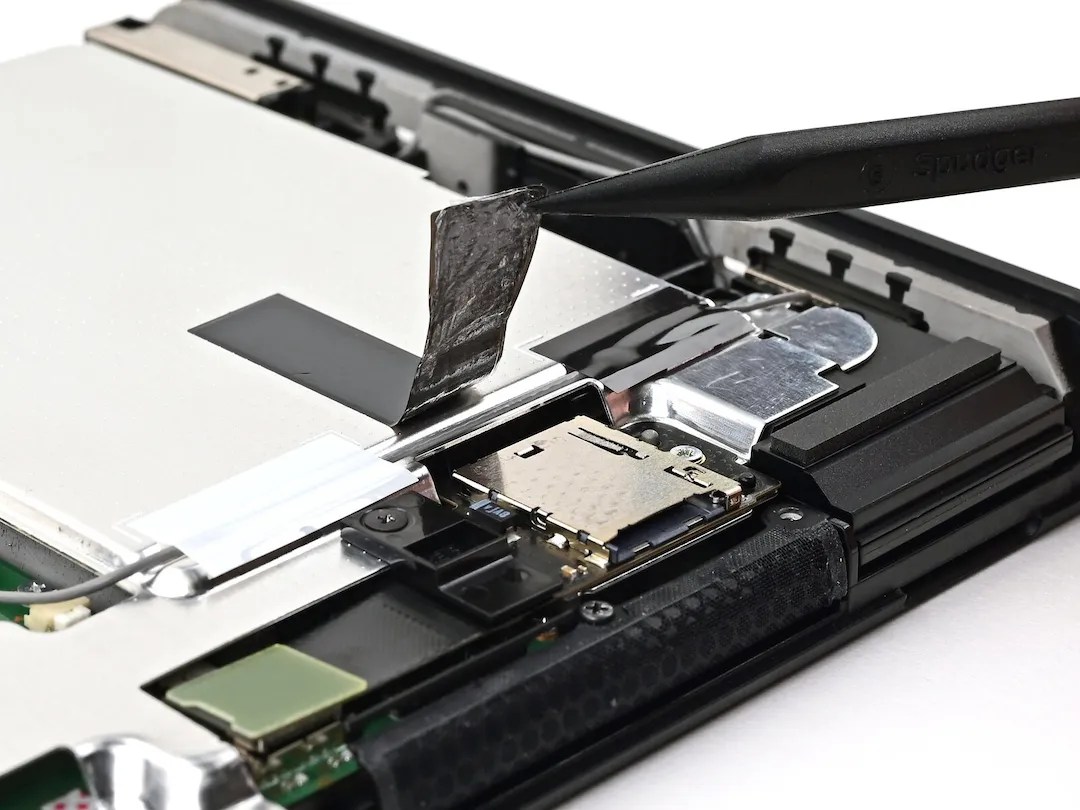 Photo of microSD Express Card connector in Switch 2, with a thermally conductive tape lifted up from the connector; other end of the tape is attached to the main shield plate https://www.ifixit.com/Guide/Nintendo+Switch+2+MicroSD+Card+Reader+Replacement/194233