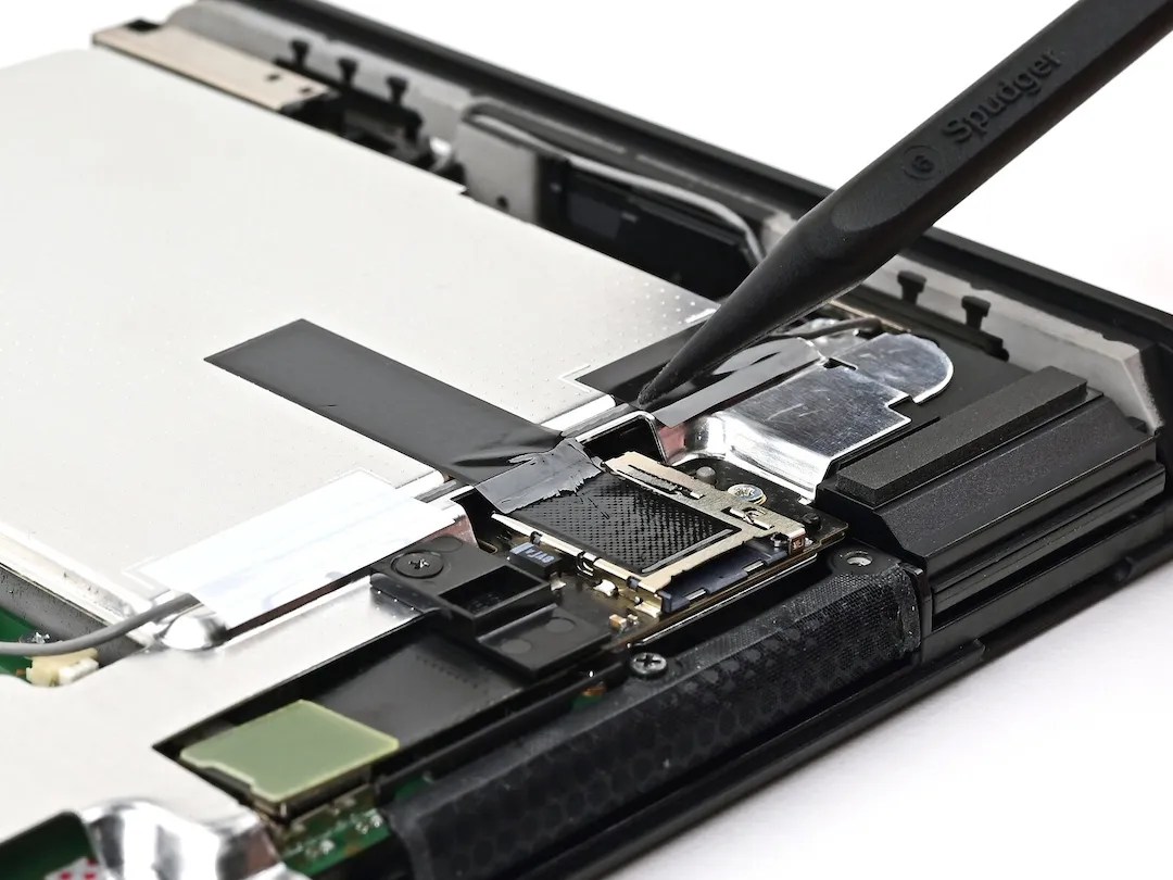 Photo of microSD Express Card connector in Switch 2, with a thermally conductive tape attached to the connector; other end of the tape is attached to the main shield plate https://www.ifixit.com/Guide/Nintendo+Switch+2+MicroSD+Card+Reader+Replacement/194233