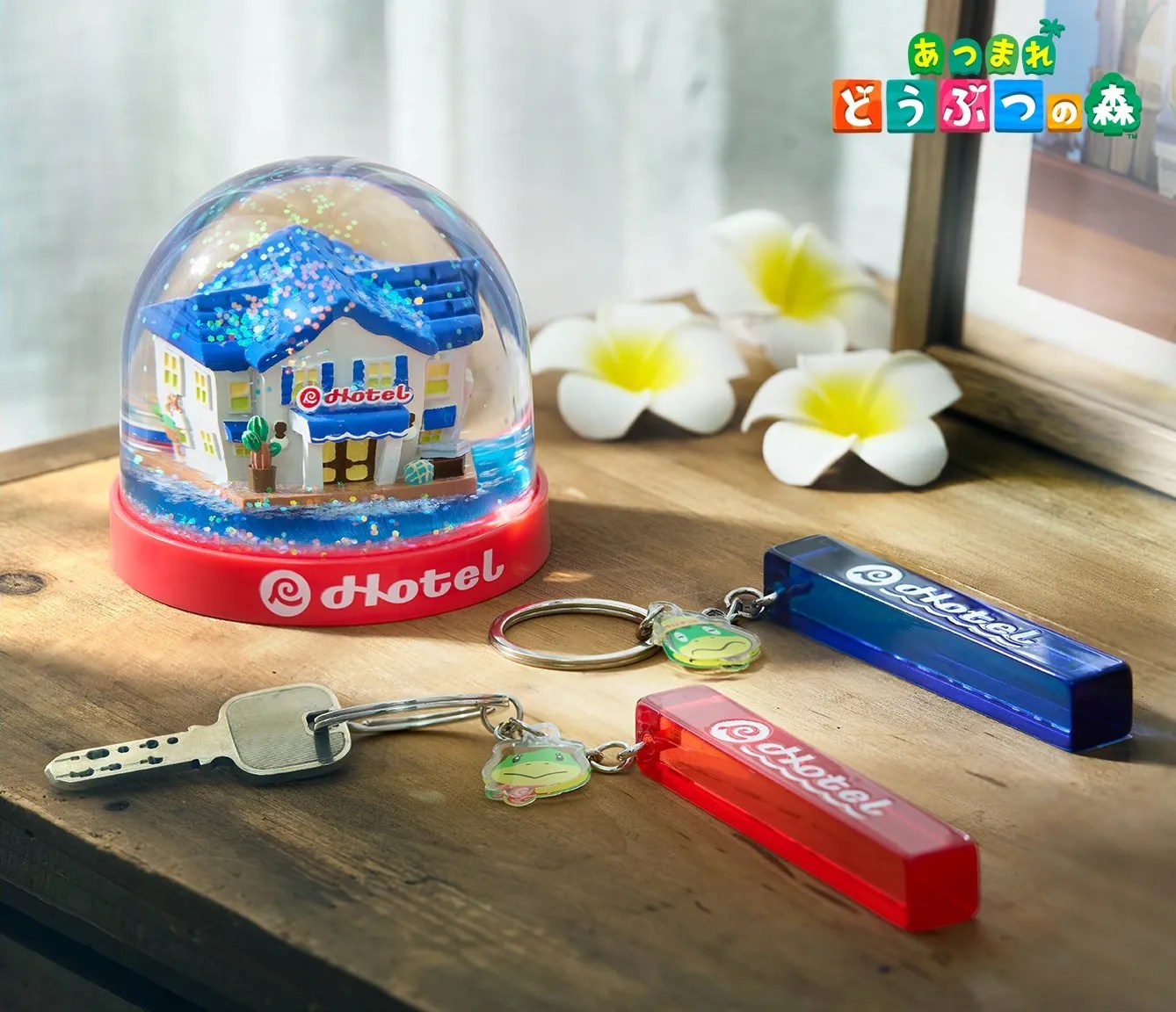 Photo of the ACNH Resort Hotel merch, including snow globe and hotel room keychains
