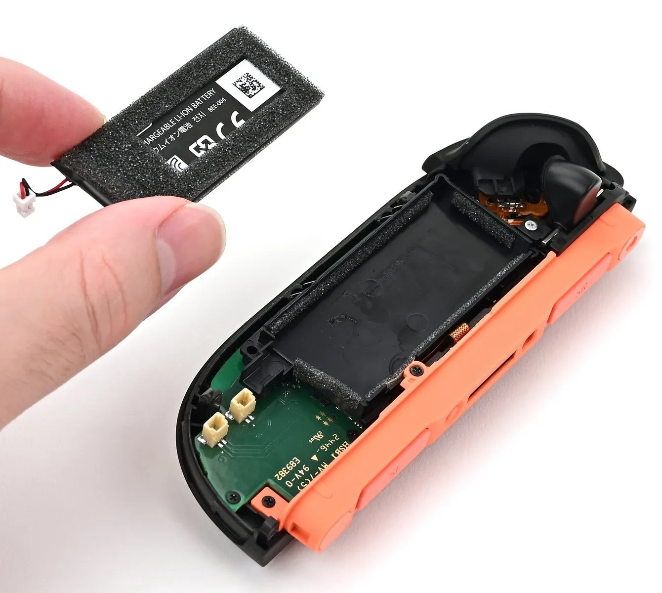 Photo of partially disassembled Joy-Con 2 (regular non-EU version); the battery is removed, but the battery frame is still attached to the Joy-Con board